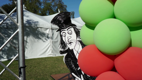Mister Snark Lurking Behind A Book Festival Balloon Display
